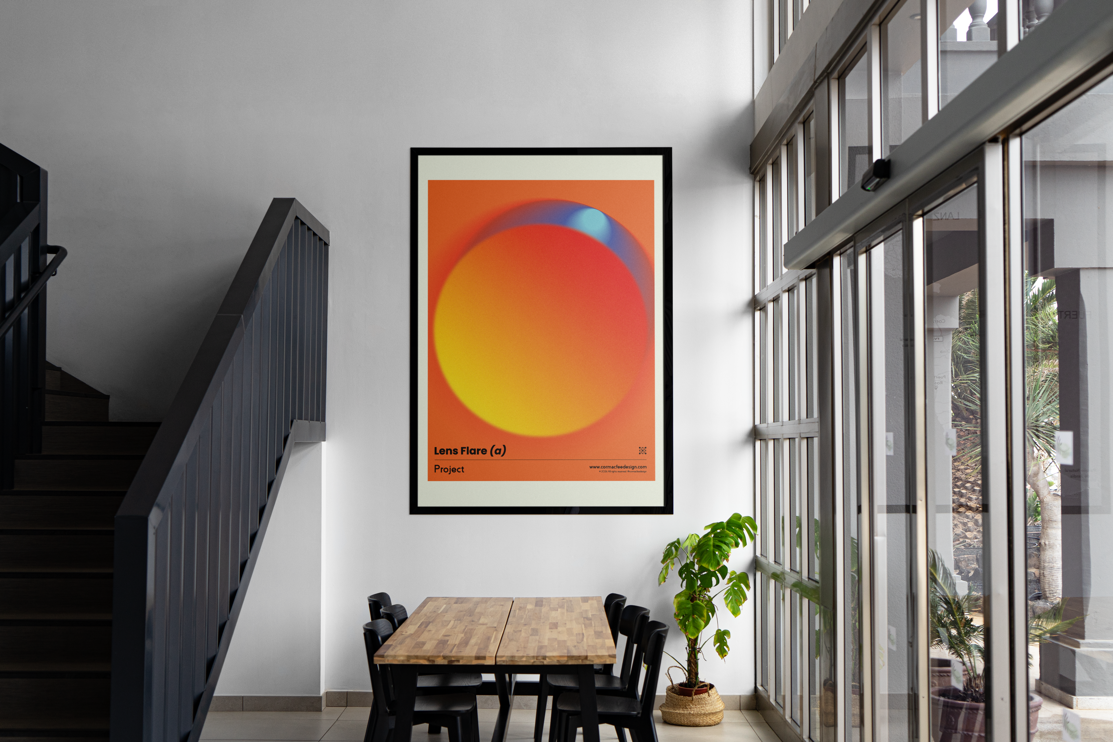 Colourful abstract art print on a wall in a modern interior setting with a staircase and table.